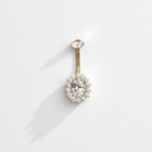 Gold belly button ring with clear gemstones on a white background