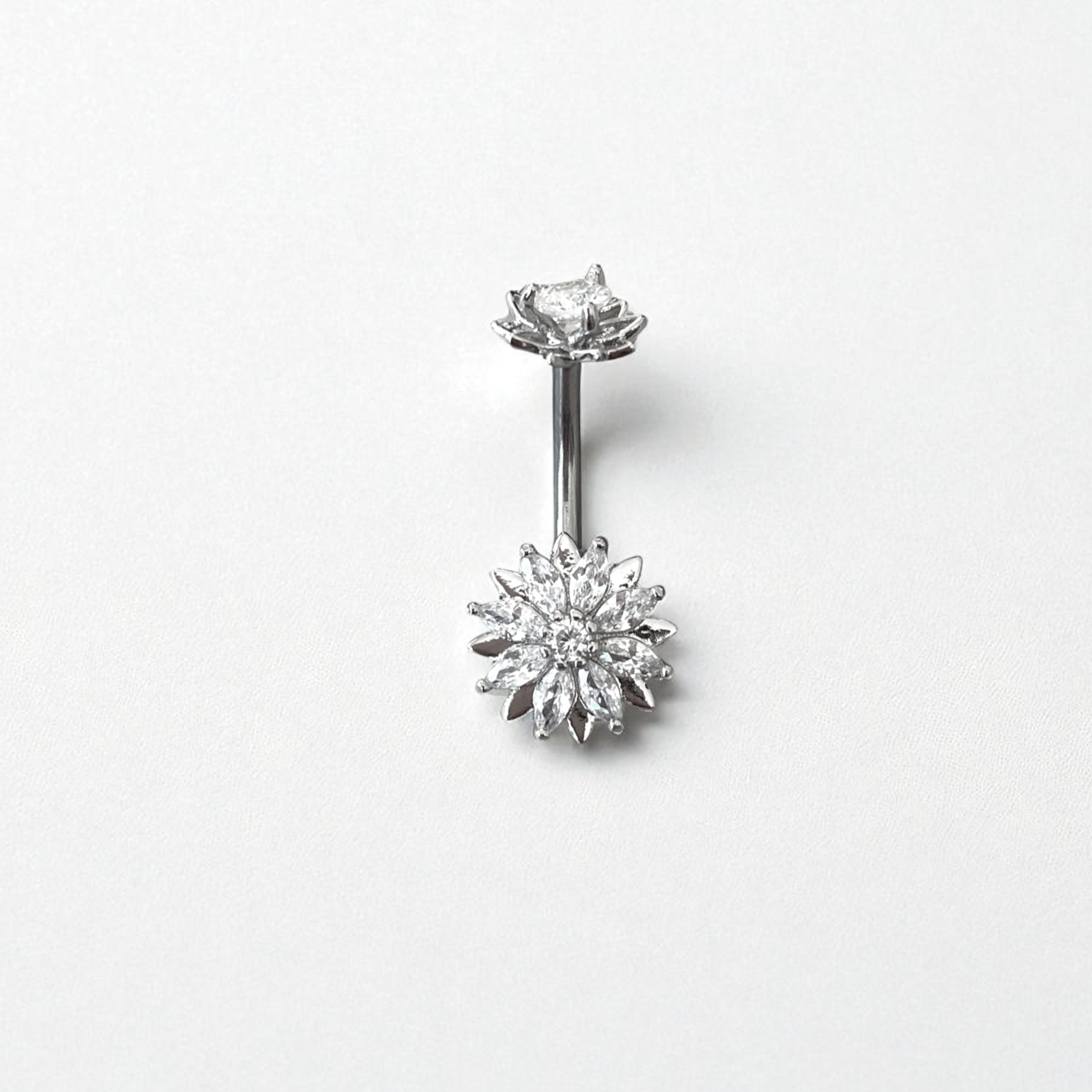 Silver belly button ring with flower-shaped top and flower-shaped bottom on a white background