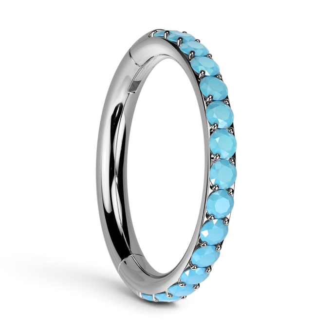 Silver cartilage hoop earring with row of turquoise-blue CZ stones