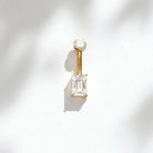 Gold belly button ring with an emerald cut moissanite