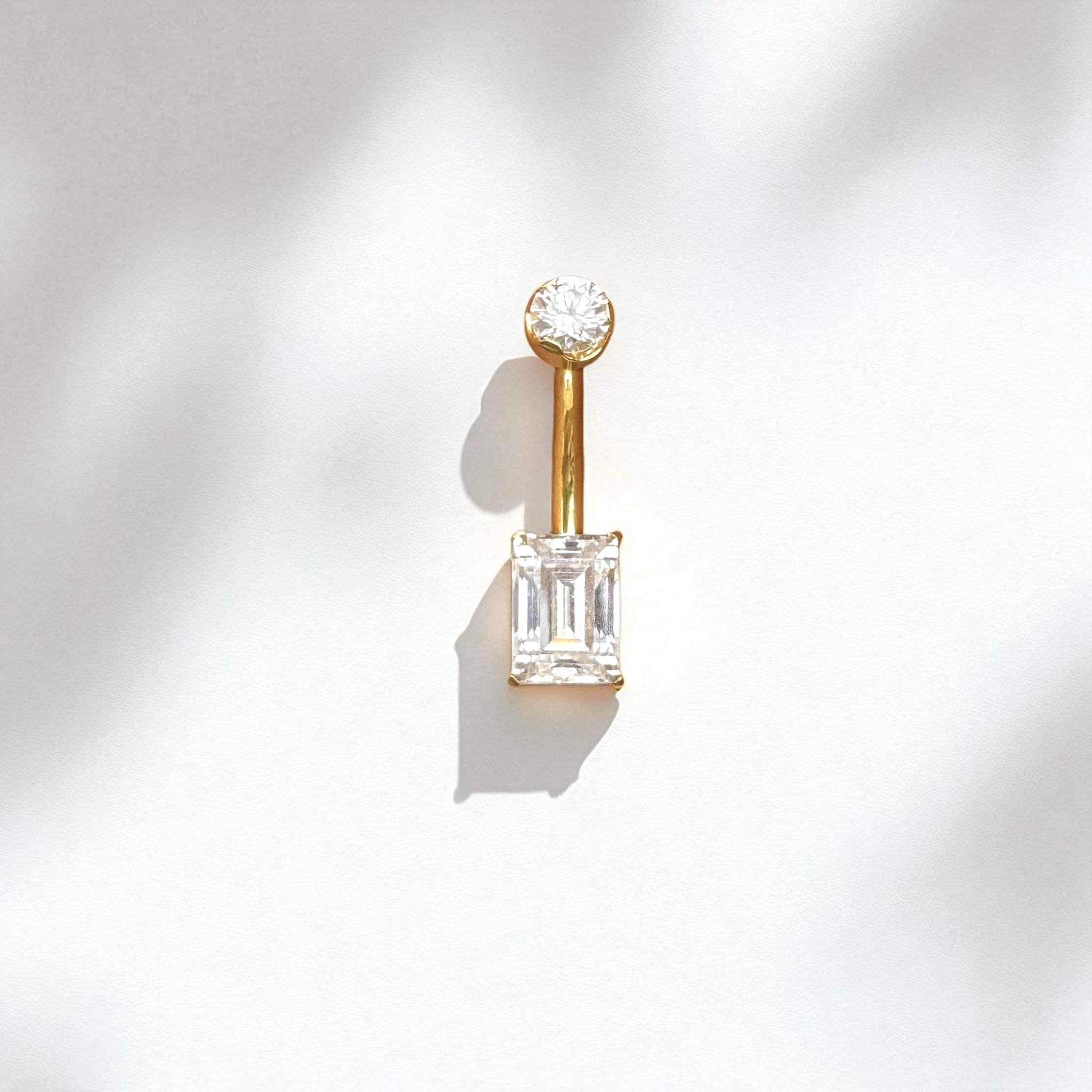 Gold belly button ring with an emerald cut moissanite