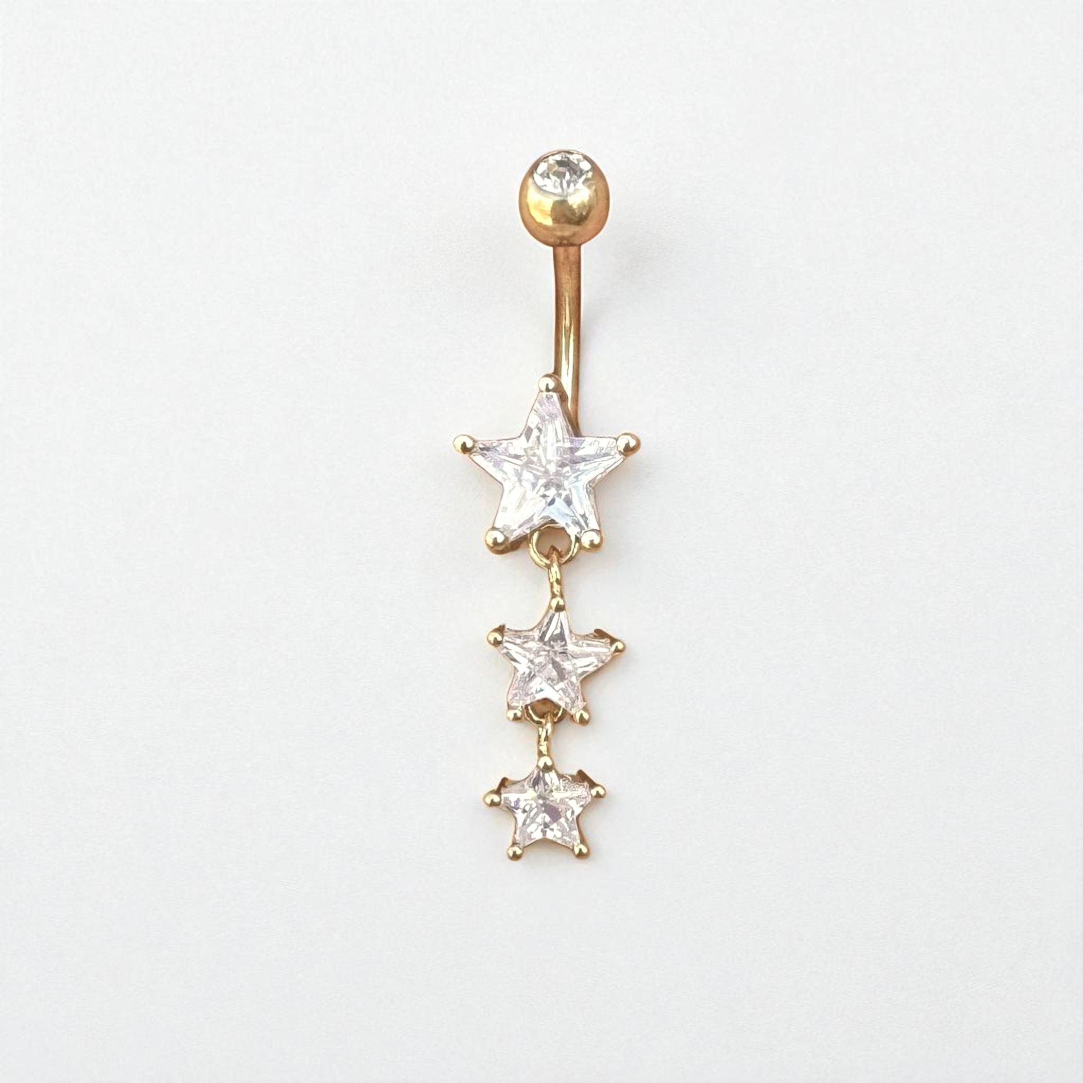 Gold belly button ring with star-shaped gemstones on a white background