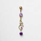 Gold belly button ring with purple gemstones on a white background