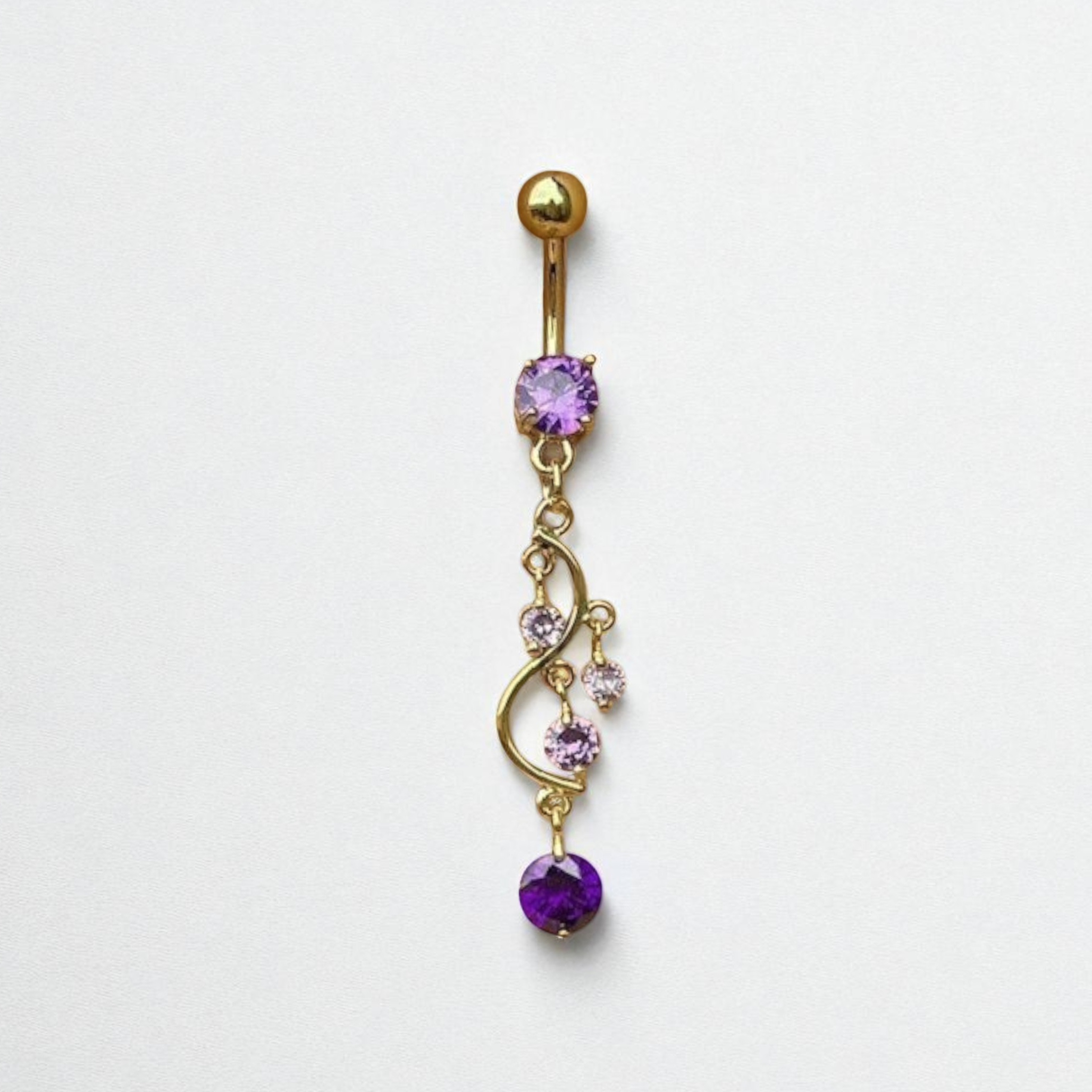 Gold belly button ring with purple gemstones on a white background