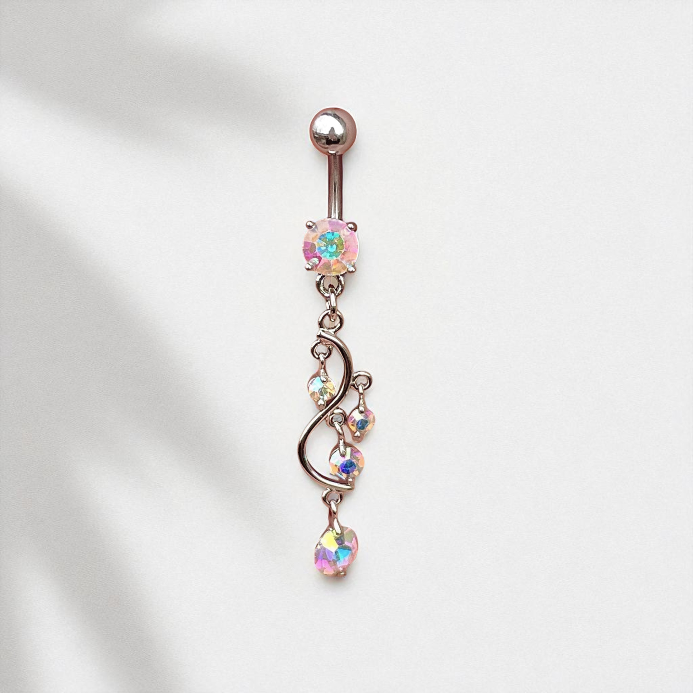 Belly button ring with colorful gemstones on a white background