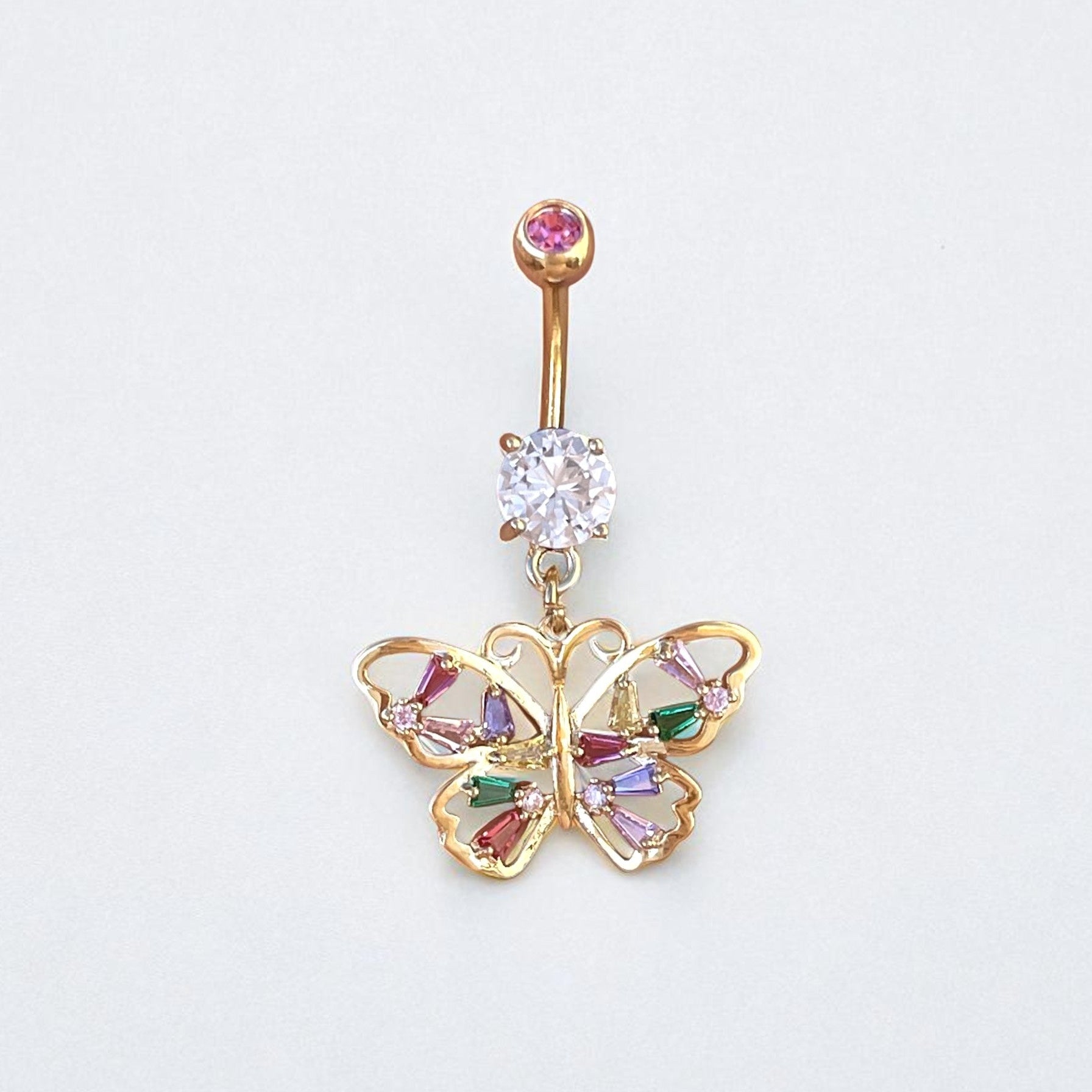 Butterfly-shaped belly button ring with gemstones on a light gray background