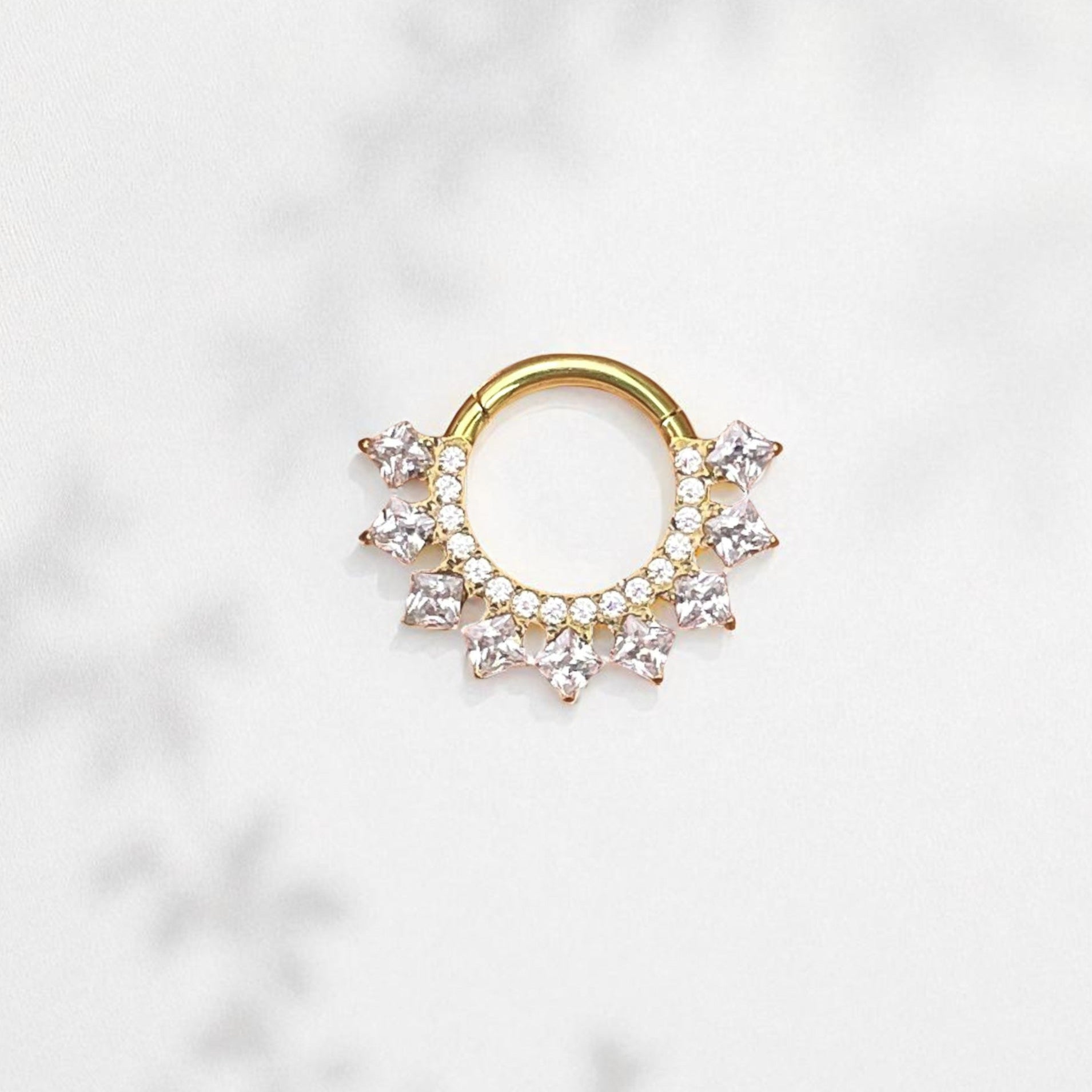 Gold daith earrings with square CZ decorations