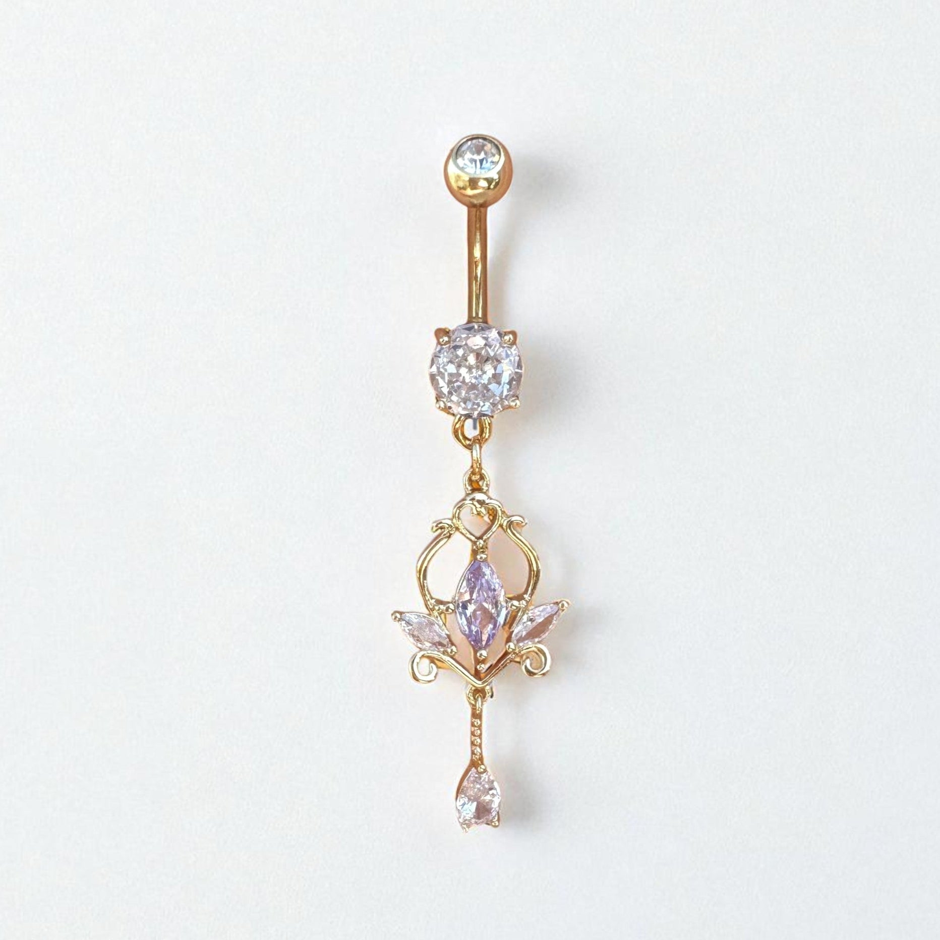 Gold belly button ring with gemstones on a white background