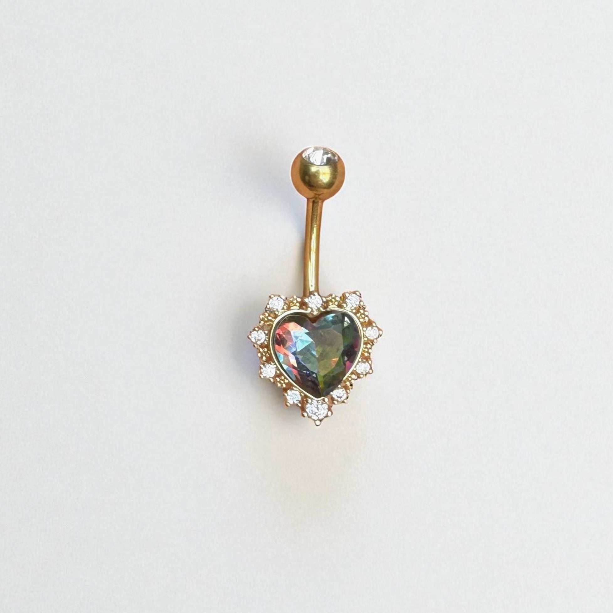 Gold belly button ring with a heart-shaped color shifting gem on a white background