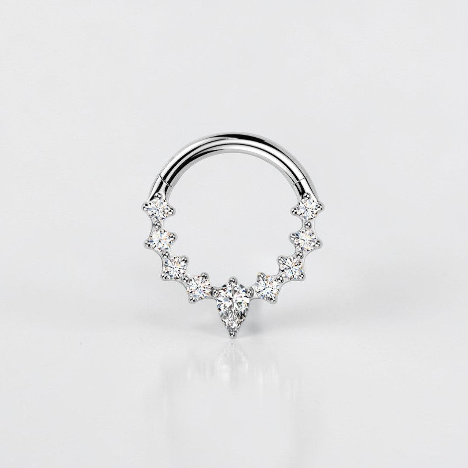 Elara Body Jewelry titanium septum ring with teardrop and round CZ stones, hinged segment closure.