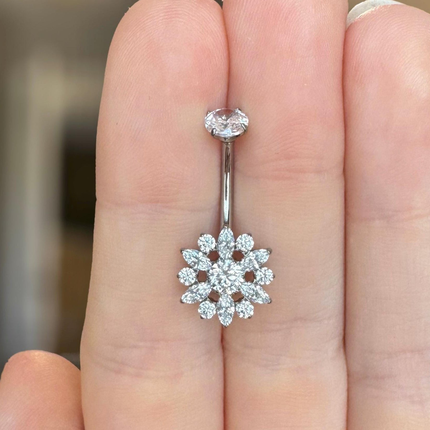 Silver belly button ring with floral CZ design