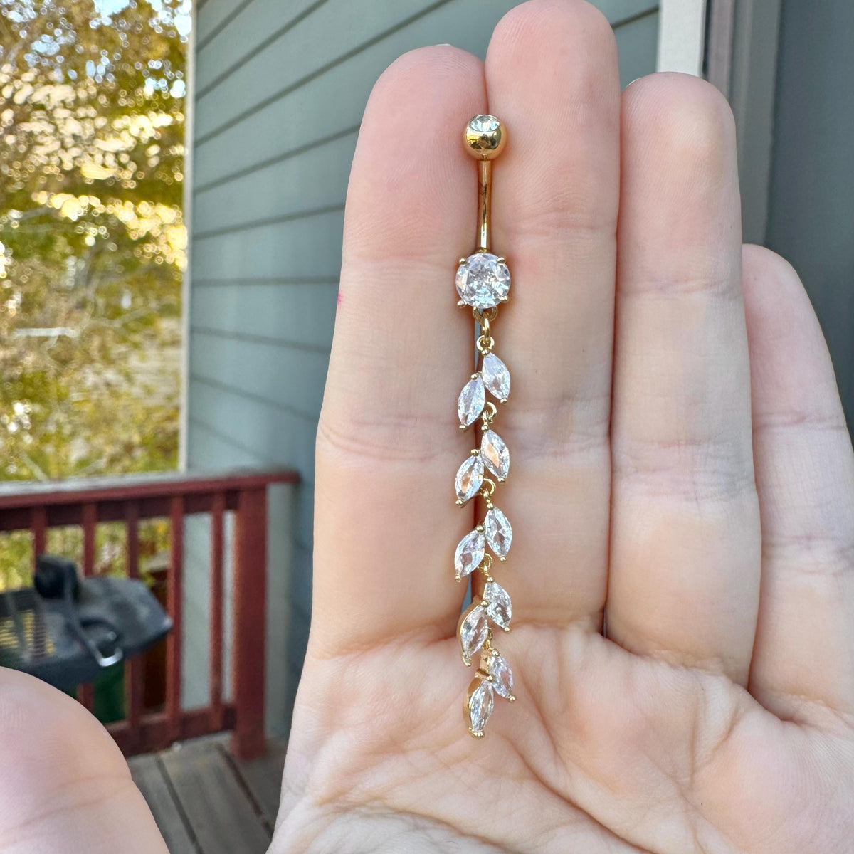 Silver dangling belly button ring with vine and leaf design, adorned with CZ stones