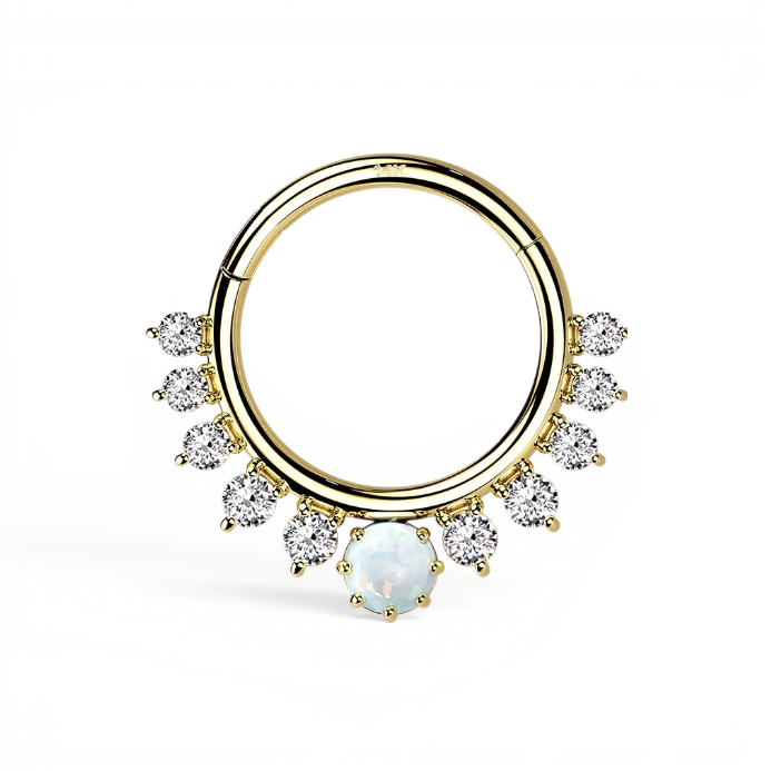 Yellow gold hinged piercing hoop with faux opal centerpiece framed by CZ accents in a sunburst-inspired design