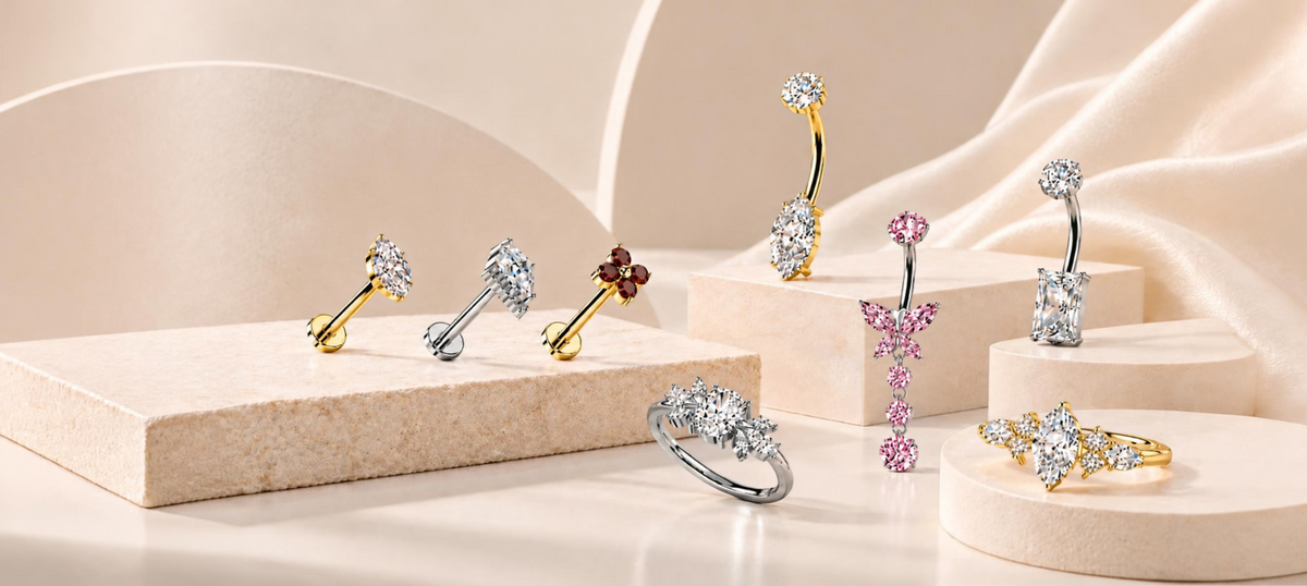 Gold and silver body jewelry displayed on decorative shelves in a studio setting