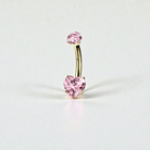 Gold belly button ring with pink heart-shaped gem on a light gray background