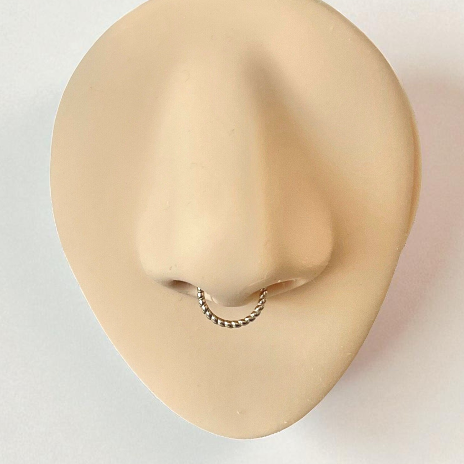 Gold Septum ring on a silicone nose
