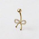 Dainty bow belly button ring with clear CZ crystals in gold finish, elegant navel piercing jewelry