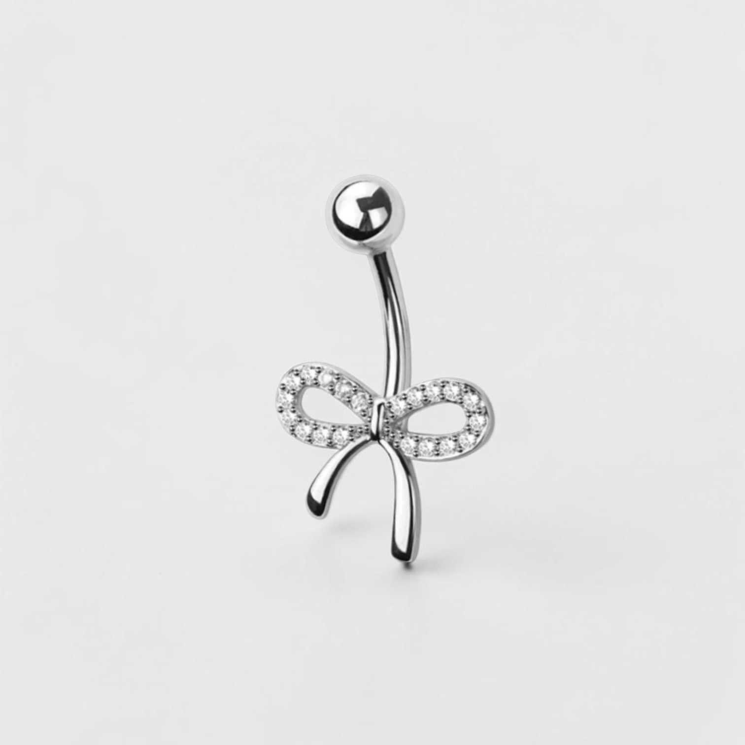 Dainty bow belly button ring with clear CZ crystals in silver finish, elegant navel piercing jewelry