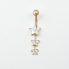 Gold belly button ring with star-shaped gemstones on a white background