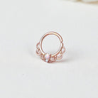 Rose gold ring with a pink opal on a light gray background