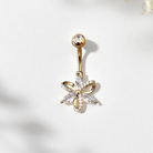 Flower belly button ring in gold, on a white background