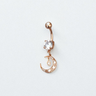 Rose gold belly button ring with a clear gemstone on a light gray background