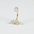 Gold belly button ring with clear gemstones on a light gray background