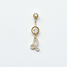 Gold belly button ring with zodiac sign gemstones on a white background