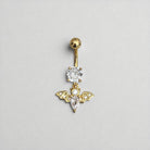 Gold belly button ring with crystal and bat design on a gray background