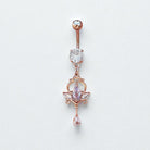 Rose gold belly button ring with gemstones on a light gray background