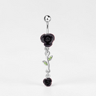 Belly button ring with black rose and green gemstone design on a white background