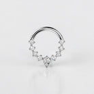 Elara Body Jewelry titanium septum ring with teardrop and round CZ stones, hinged segment closure.