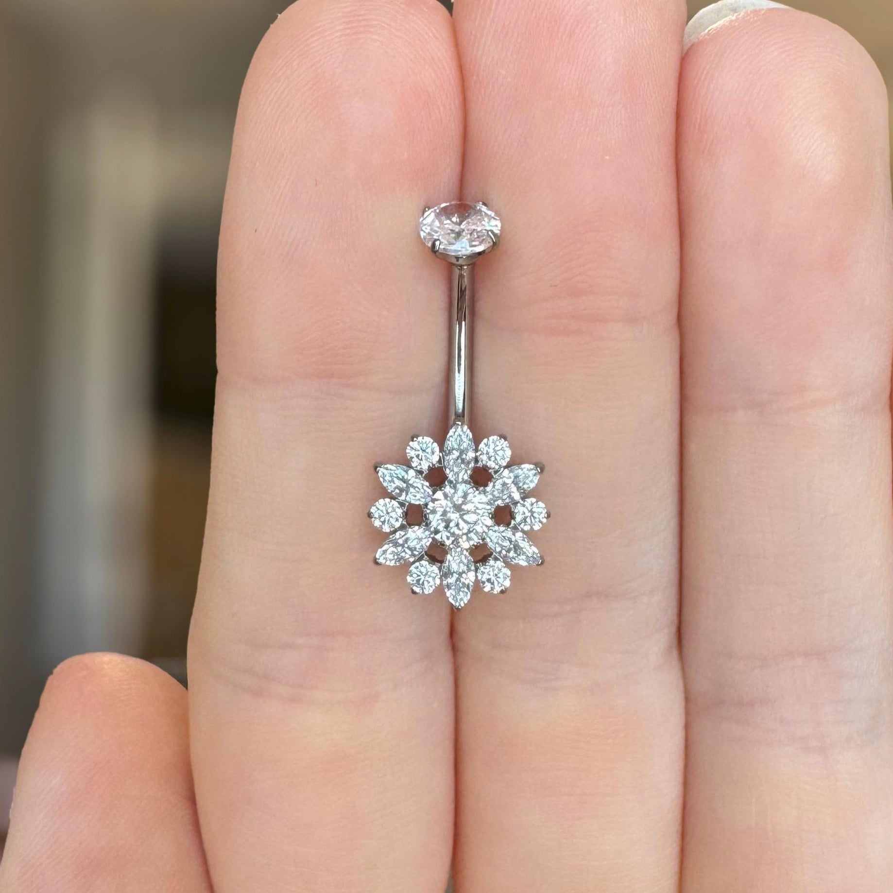 Silver belly button ring with floral CZ design 